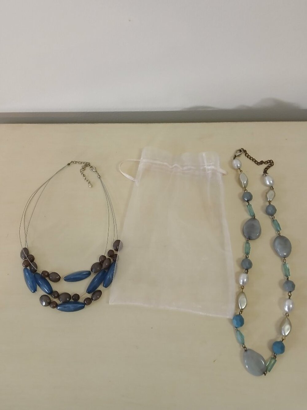 2 beaded necklaces with sheer jewelry bag